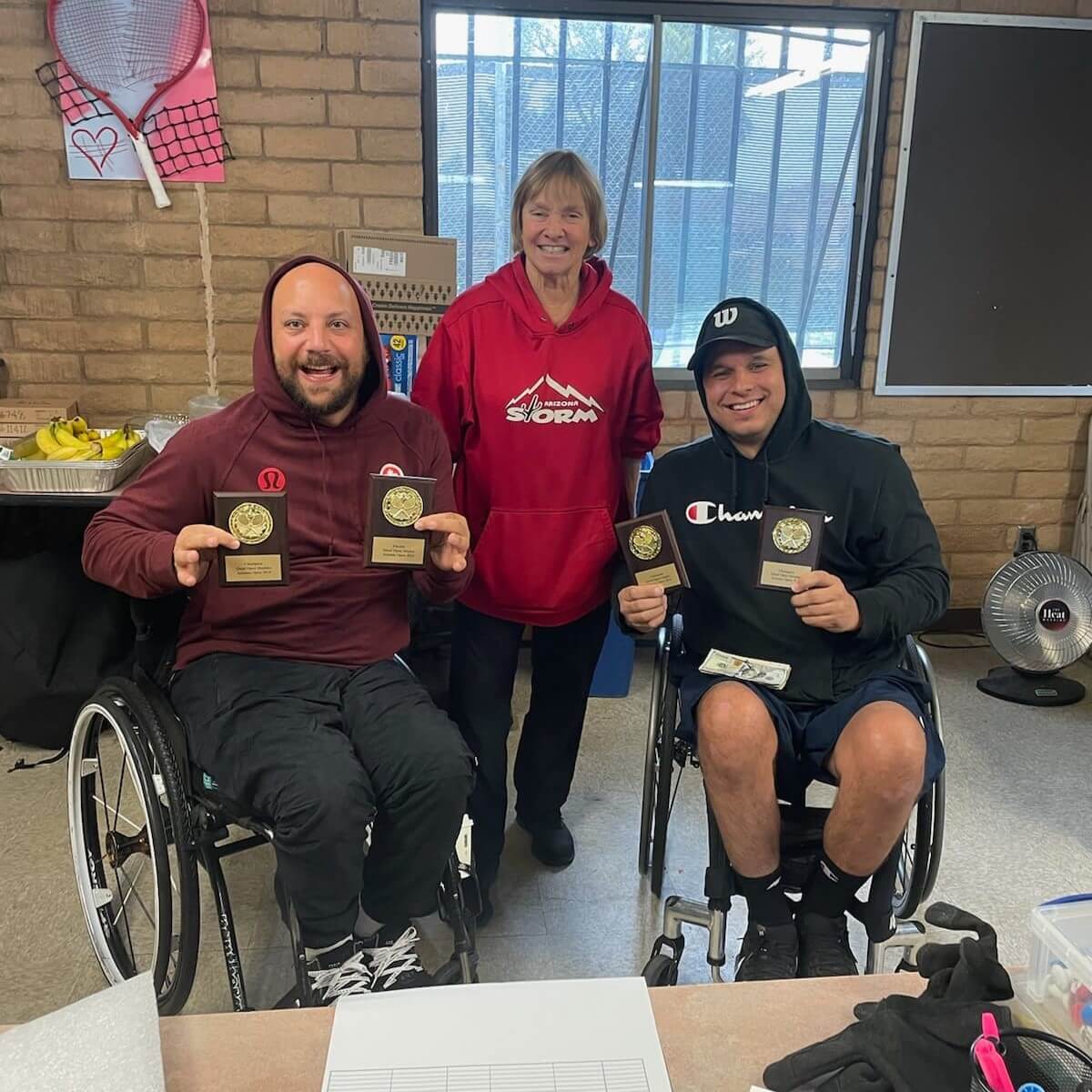 Mitch McIntyre poses with his trophies and his Doubles partner at the Arizona Open